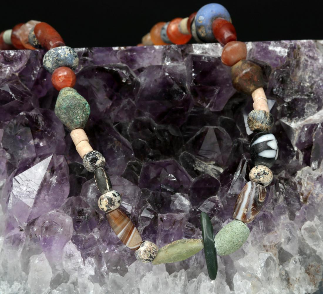 Ancient Roman Necklace w/ Glass, Stone & Faience Beads: **First Time At Auction** Roman, Imperial Period, ca. 2nd to 4th century CE. A beautiful necklace comprised of dozens of ancient beads - faience, glass, and various stones including carnelian and gree
