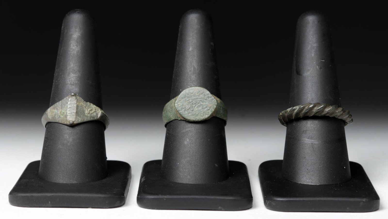 Trio of Viking Bronze Finger Rings: **First Time At Auction** Northern Europe, Viking / Norse culture, ca. 800 to 1100 CE. Three wonderful cast-bronze finger rings, each with its own unique style. First is a simple ring with a thin band