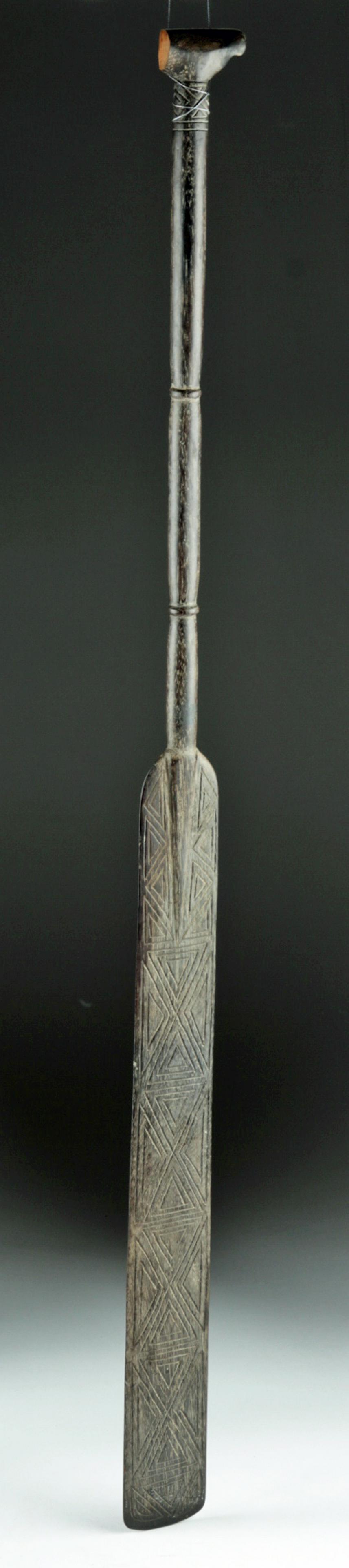 20th C. Melawi Dayak Wood Dance Paddle: **First Time At Auction** Southeast Asia, Indonesia, Borneo, West Kalimantan, Dayak peoples, ca. mid 20th century CE. An elegant paddle used in ceremonial dances, carved of a very dark wood, with ligh