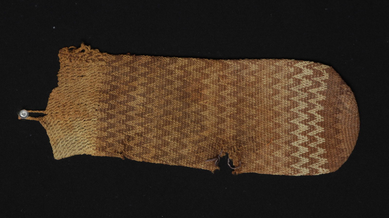 Chiribaya Textile Shaman's Pouch: **First Time At Auction** Pre-Columbian, Western Bolivia, Chiribaya or Tiahuanaco (Tiwanaku), ca. 900 to 1200 CE. A lengthy and lovely textile pouch comprised of tightly-woven natural fibers in hues o