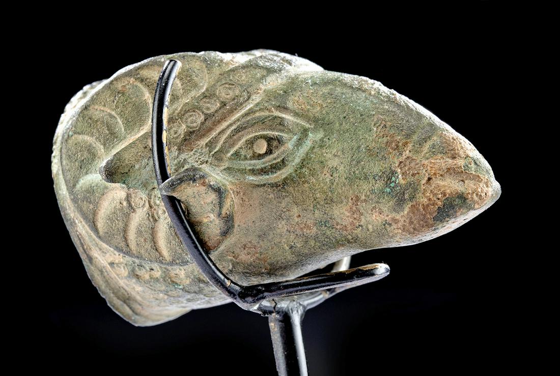 Miniature Roman Bronze Ram Head: Rome, Imperial Period, ca. 1st to 4th century CE. A very endearing, solid cast bronze ram's head with finely delineated features: spiraled horns, almond-shaped eyes, projecting ears, a prominent snout