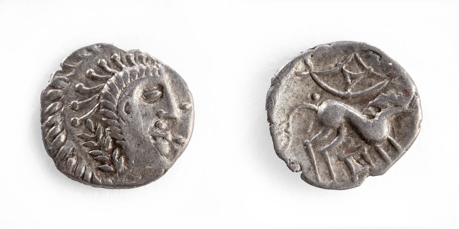 Celtic Britain Queen Boudicca Silver Unit Coin: Celtic Britain, Queen Boudicca, ca. 65 to 61 BCE. AR Unit. Obverse: Stylized head right, a trefoil ornament in front. Reverse: A horse leaping right, a wheel-like symbol above. S. 434. VA 790-794. Siz