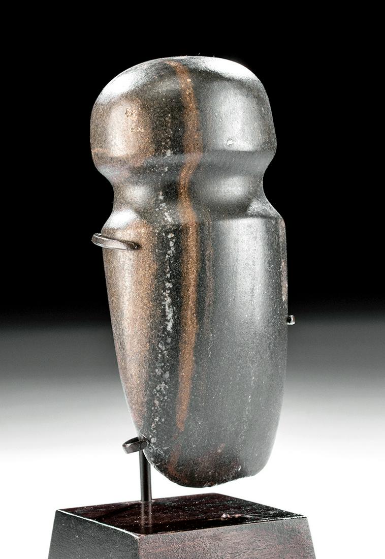 Native American Woodland Stone Full Groove Hand Axe: Native American, Midwest/Southern United States, Woodland culture, ca. 100 BCE to 400 CE. A lovely hand axe that is hand-carved from dark-grey stone with streaks of white and beige. The axe has a shal