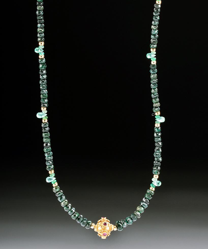 Mughal Indian Gold & Ruby Pendant on Emerald Necklace: Central Asia, India, Mughal Empire, ca. 17th to 18th century CE. A striking and ornate 77% gold (equivalent to 18K+) pendant studded with six cut rubies. Each inlaid ruby is encircled by granulations,