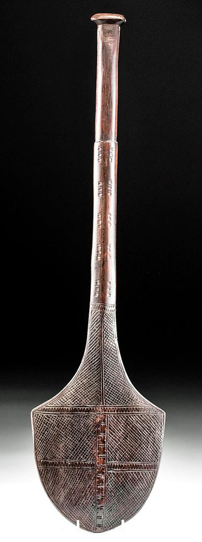 20th C. Fiji Wood War Club: Oceania, Fiji Islands, ca. mid 20th century CE. A fine example of a carved wooden club featuring an acorn-shaped striking surface incised on both sides with dense cross hatching and geometric motifs;