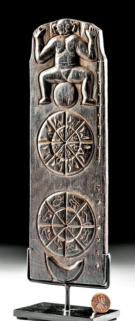 20th C. Ngaju Dayak Wood Ritual Calendar: Indonesia, Borneo, Central Kalimantan, Ngaju Dayak peoples, ca. mid 20th century CE. A well-carved ritual calendar, made from a dark hardwood, of an elongated trapezoidal form and with carving on fron