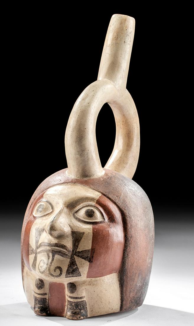 Moche Polychrome Portrait Vessel of Dwarf w/ Tattoos: Pre-Columbian, Peru, Moche III to Moche IV (Classic Period), ca. 450 to 650 CE. A strikingly lifelike mold-made portrait stirrup vessel, with the individual's visage and body finely modeled to form th