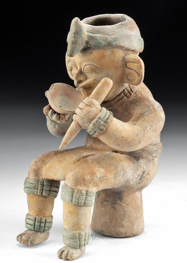 Very Fine Jamacoaque Pottery Seated Shaman w/ Bowl: Pre-Columbian, Ecuador, Jamacoaque culture (also Jama Coaque), ca. 500 CE. A masterfully hand-built, skillfully modeled, and beautifully painted shaman figure who sits upon a stool or drum and holds a
