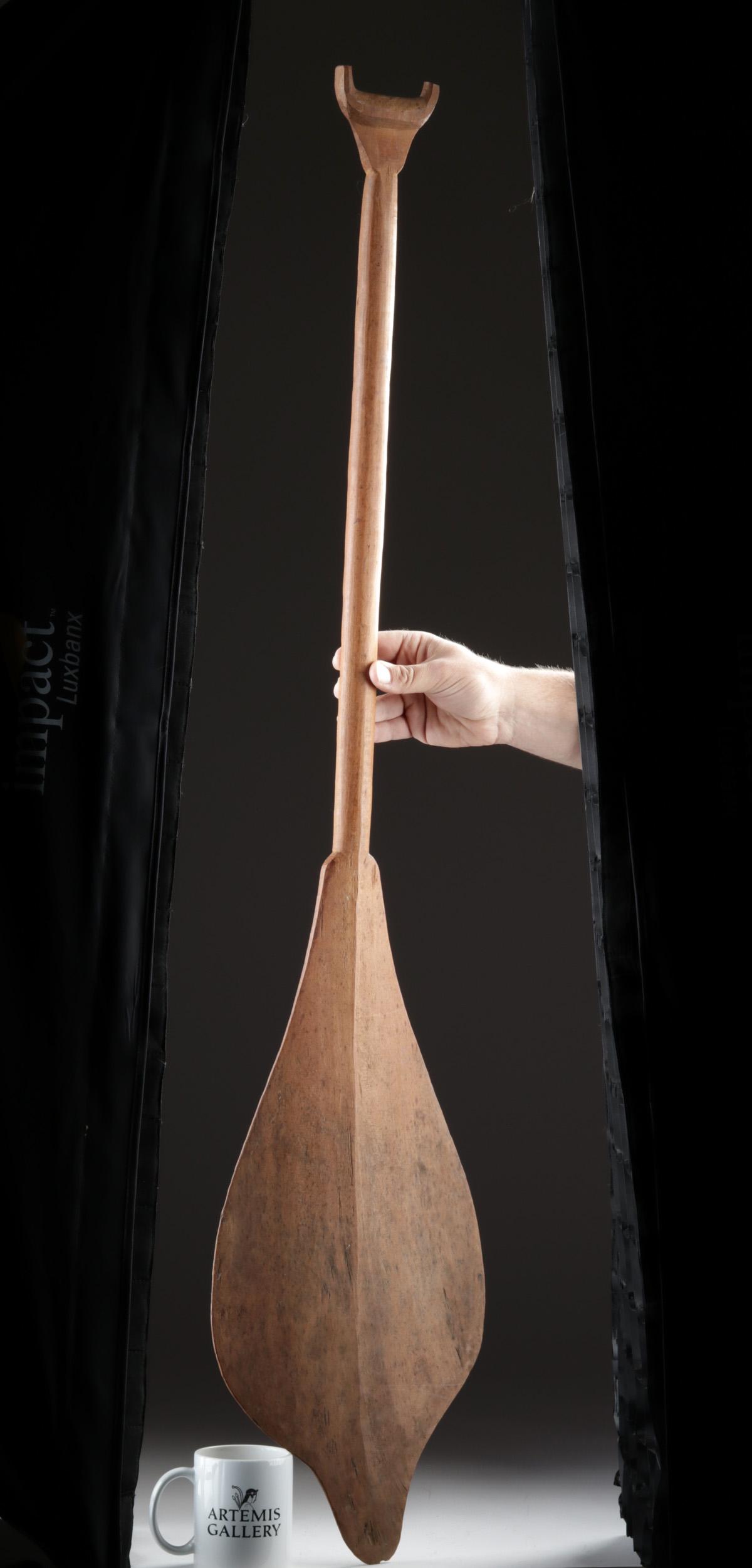 Early 20th C. Shipibo / Conibo Wooden Canoe Paddle: South America, Upper/Western Amazon Basin, Peru, Ucayali River, Shipibo/Conibo peoples, ca. early to mid 20th century CE. A hand-carved wooden canoe paddle with a lengthy handle, a forked terminal, an