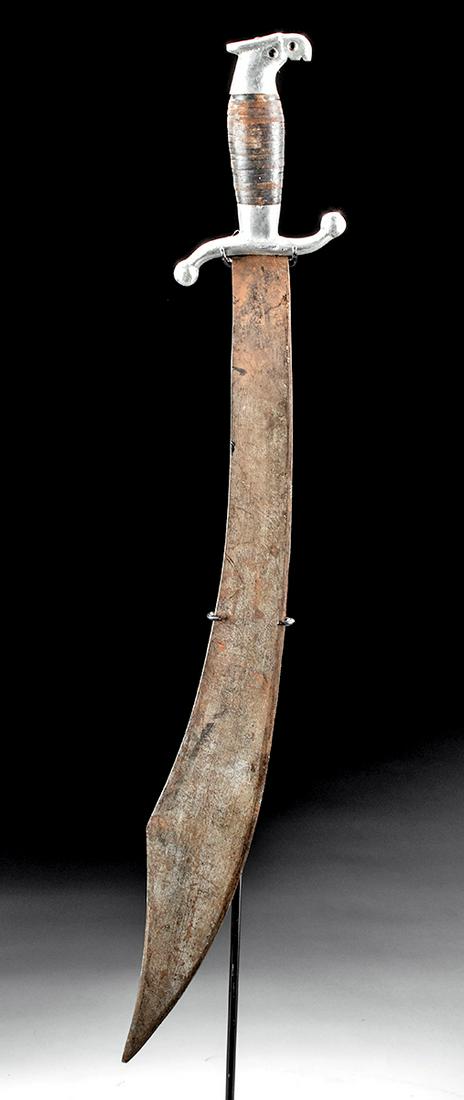 20th C. Mexican Noriega Steel Machete / Scimitar: North America, Mexico, ca. 20th century CE. A handsome steel scimitar or machete, featuring a slightly curved blade with a wide tip that is thin in cross-section and sharpened on its inside edge. The