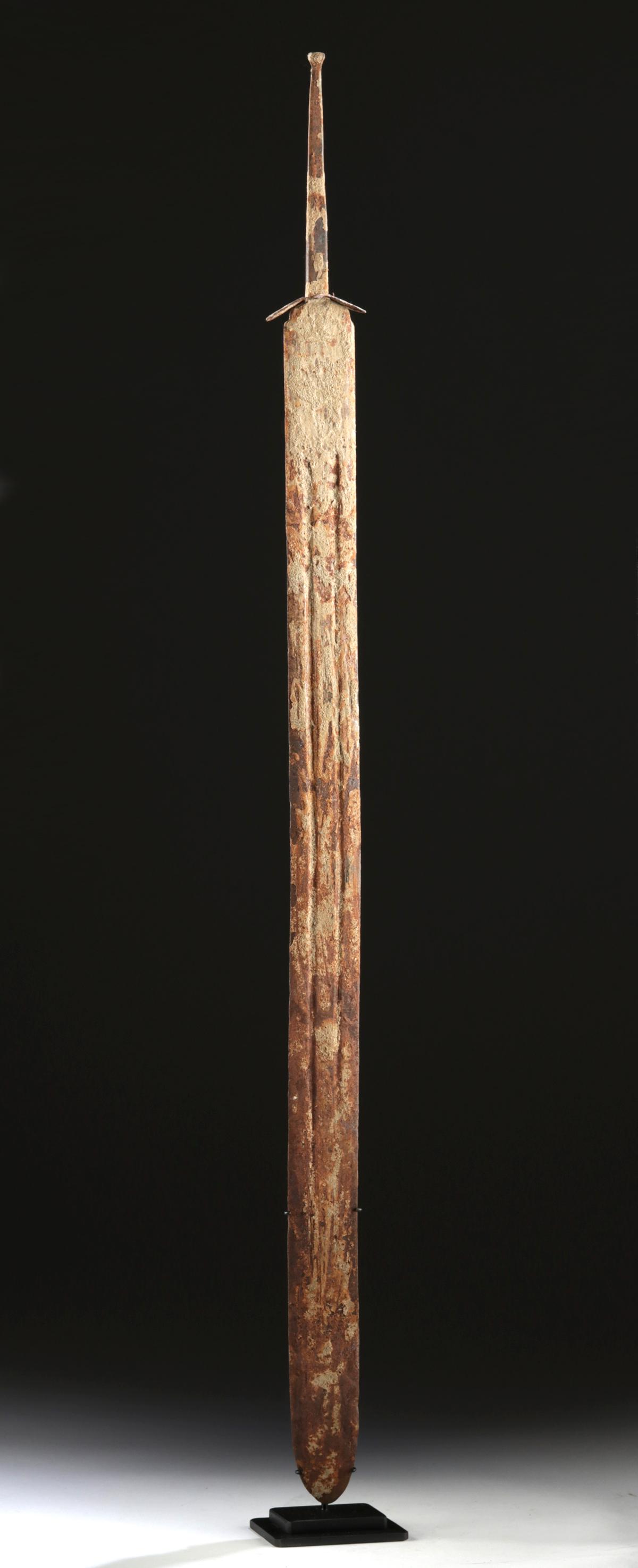 5th C. Celtic La Tene Forged Iron Sword: Ancient Central / Northern Europe, Celtic Iron Age, La Tene culture, ca. 5th to 1st century BCE. A stunning forged-iron sword with an elongated blade bearing sharpened edges, a pair of parallel groove