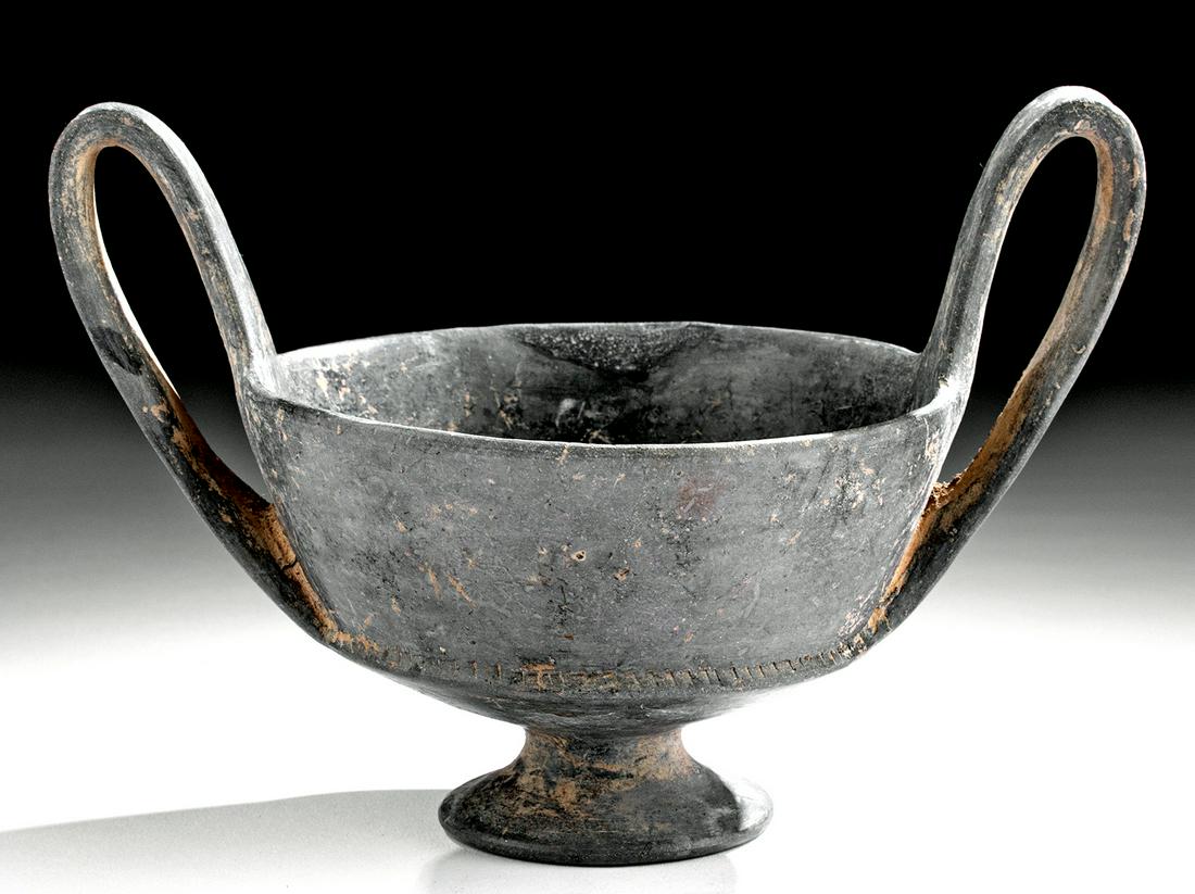 Etruscan Buccheroware Kantharos: **Originally Listed At $400** Classical World, Etruria, ca. late 7th to 6th century BCE. A fine wheel-thrown pottery kantharos (wine cup) with distinctive high handles. The body has gradually expandin