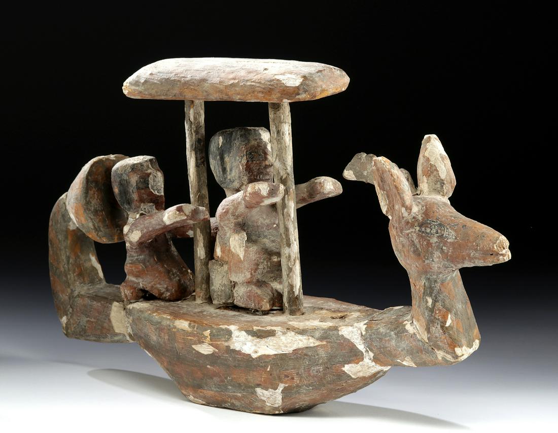 Egyptian Wood/Painted Gesso Funerary Boat + Oarsmen: Ancient Egypt, New Kingdom, 18th to 20th Dynasty, ca. 1549 to 1076 BCE. A finely preserved, hand-carved wooden model of a funerary boat with a tapered base, a flat top with a trio of narrow mortises, 