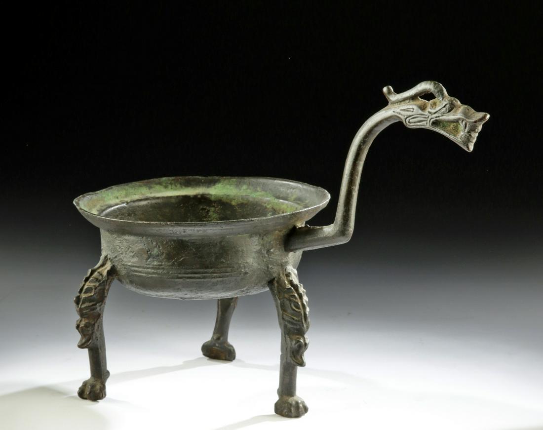 Chinese Han Dynasty Bronze Vessel w/ Dragon Handle: East Asia, China, Han Dynasty to Six Dynasties period, ca. 206 BCE to 589 CE. A cast-bronze ritual pouring vessel known as a "chiaotou" (also chiao-tou, jiaodou). The vessel body has a wide, upturned 