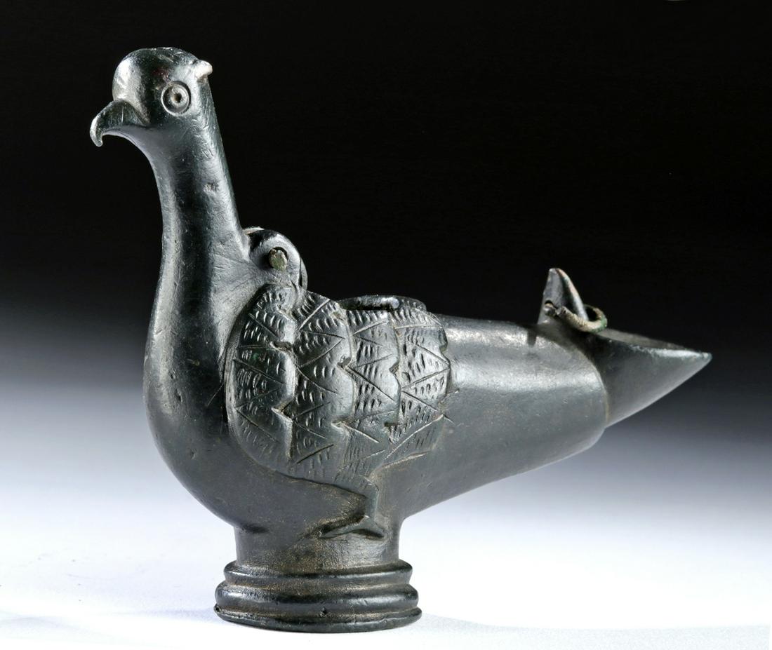 11th C. Seljuk Leaded Bronze Oil Lamp - Bird Form: Central Asia, Persia, Seljuq, ca. 1040 to 1196 CE. A finely cast bronze oil lamp depicting a perched bird with a beaked visage atop a long neck at the front of the vessel, low relief and incised feath