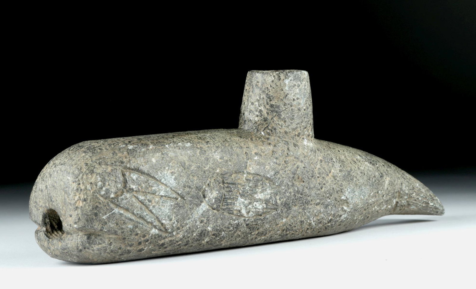 19th C. Alaskan Soapstone Smoking Pipe - Whale Form: Native American, Alaskan, ca. 19th century CE. A hand-carved, heavy soapstone smoking pipe in the form of a whale. The whale has huge eyes, each carved as if having two long, ray-like streamers flowin