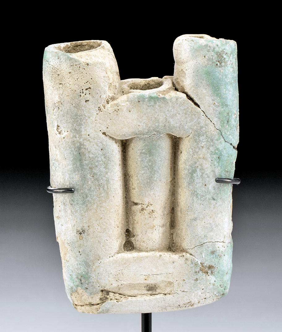 Egyptian Faience Kohl Cosmetic Container - 3 Tubes: Ancient Egypt, New Kingdom, 18th Dynasty, ca 1550 to 1069 BCE. A wonderful green faience kohl container comprised of three conjoined tubes, the central tube recessed, all with remains of turquoise gla