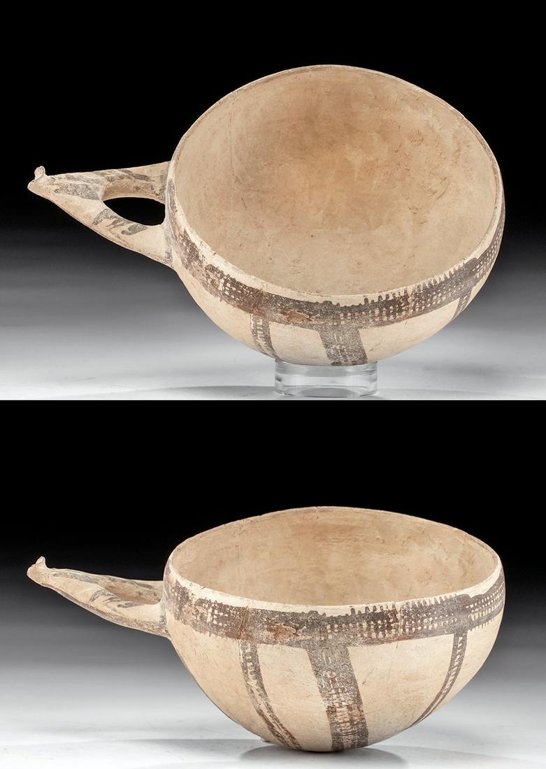Bronze Age Holy Land Painted Pottery Dipper: Ancient Near East / the Levant / Holy Land, Deir Sammit, Hebron, Late Bronze Age, ca. 1500 to 1250 BCE. A large, delicate, rounded buff clay vessel with a single loop wishbone-shaped handle projecting