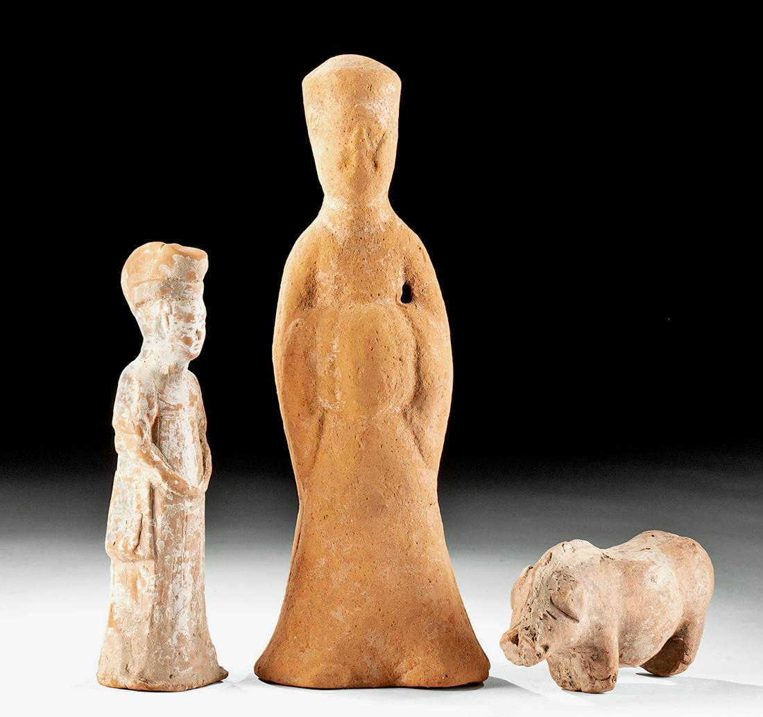 Lot of 3 Chinese Han & Tang Dynasty Terracotta Pieces: East Asia, China, Han Dynasty, ca. 206 BCE to 220 CE; Tang Dynasty, ca. 618 to 907 CE. A fine set of three mold-formed terracotta figures from the Han and Tang Dynasties of ancient China. First is a c