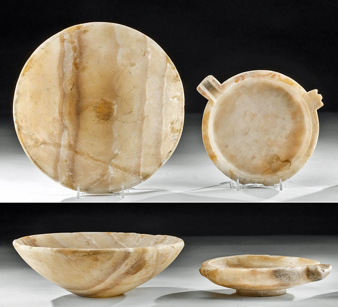 Lot of 2 Large Bactrian Alabaster Offering Dishes: Ancient Central Asia, Bactrian, ca. 3rd to 2nd millennium BCE. A pair of complementary alabaster offering dishes. The larger is a shallow bowl with a small, rounded but stable base and thin walls that