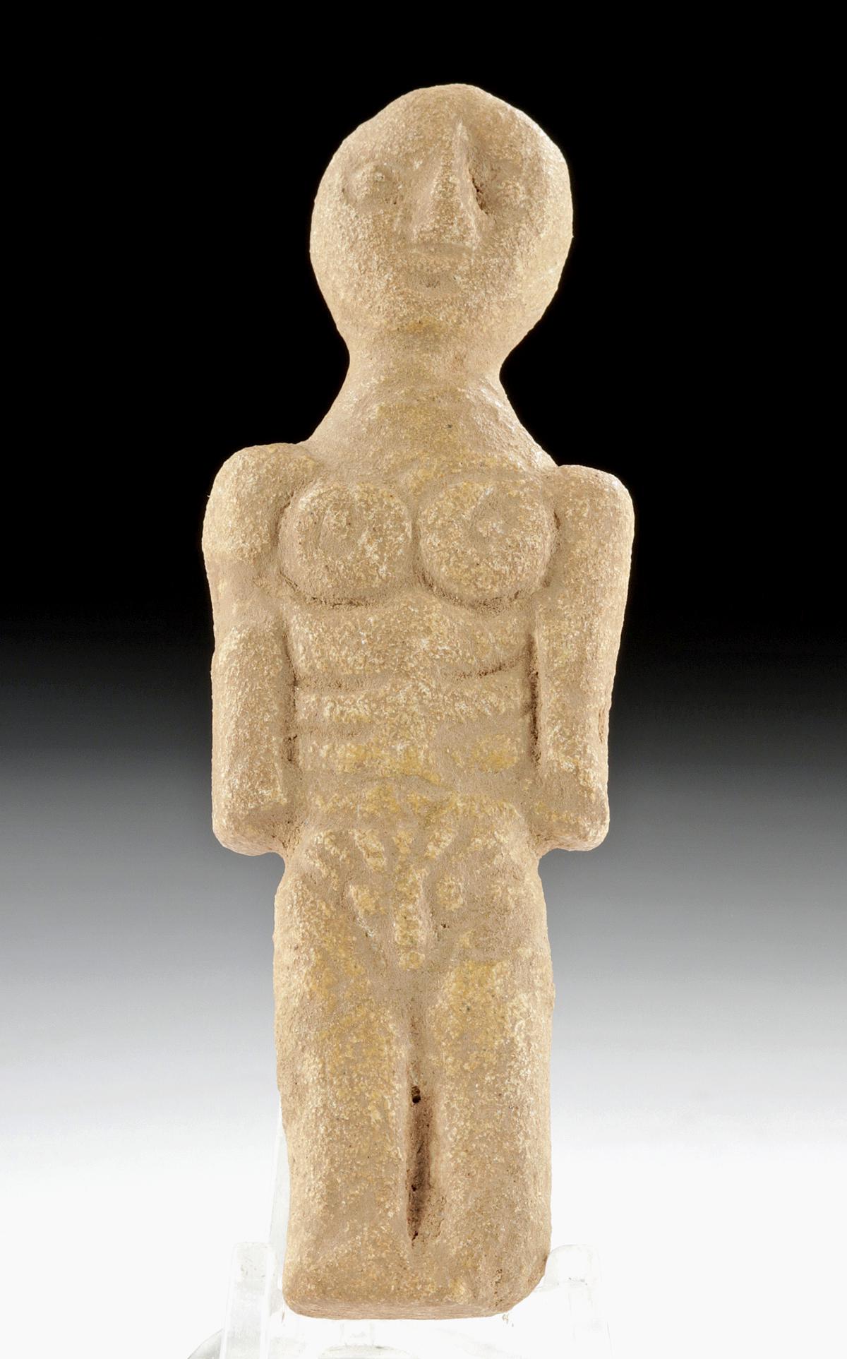 Rare Iberian Stone Male Figurative Effigy: Western Europe, Spain, Iberian Peninsula, ca. 5th to 4th century BCE. An intriguing figurative effigy of a rare form depicting a male standing atop fused legs with a vertical delineation cleft. The nu