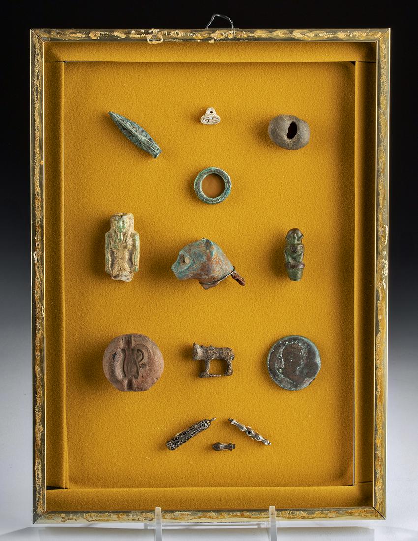 Collection of Egyptian, Roman, & Medieval Items (12): **Originally Listed At $550** Ancient Egypt, Late Period, ca. 664 to 332 BCE. A white faience stamp seal, a faience ushabti, a bronze cat head from a larger statue, a faience monkey, a bronze ring, an