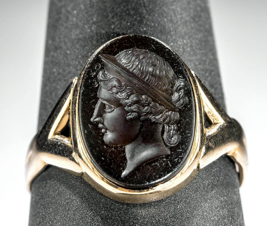 12K Rose Gold Ring w/ Neoclassical Glass Intaglio Venus: **Originally Listed At $500** Europe, Neoclassical period, ca. 19th century CE. A beautiful intaglio of an ovoid form made from warm vermilion-hued glass. The face of the intaglio features a stunningl