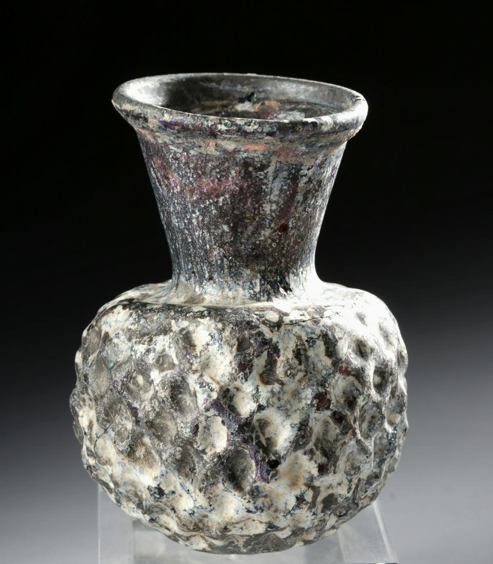 5th C. Byzantine Glass Flask Dimpled Netting: Ancient Near East, early Byzantine Empire, ca. 5th to 7th century CE. A lovely mold-formed glass flask, of a petite form shaped from gorgeous aubergine-hued glass, with a lightly-concave base, a spher