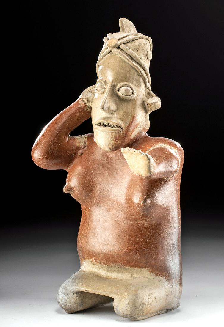 Exhibited Jalisco Ameca Grey Pottery Female Figure: Pre-Columbian, West Mexico, Jalisco, Ameca Grey type, Protoclassic Period, ca. 100 BCE to 250 CE. A fabulous hollow-bodied pottery statue depicting a kneeling female with a skirt covering the tops of 