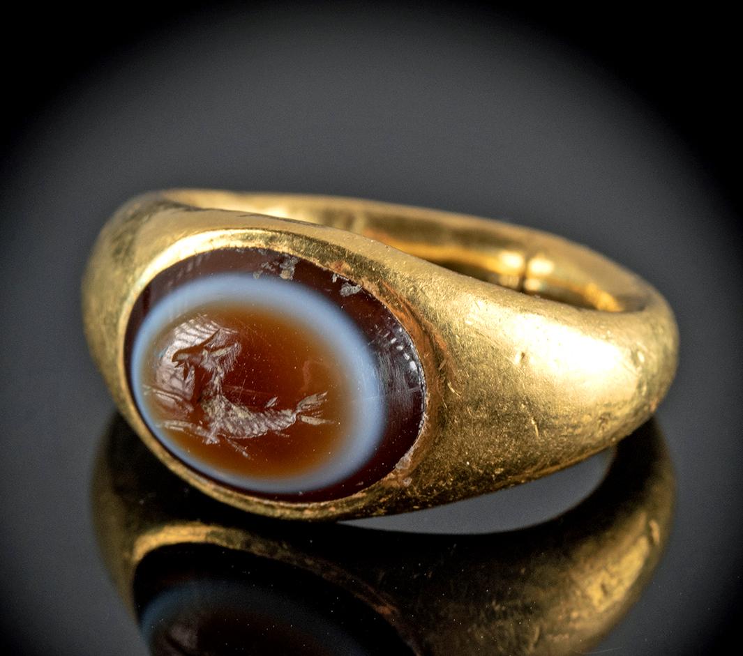 Roman 22K+ Gold & Sardonyx Intaglio Ring w/Hippocamp: Roman, Imperial Period, ca. 2nd to 4th century CE. A beautiful ring comprised of 92.5% gold (equivalent to 22K+) with an elegantly curved band and an ovoid inset banded sardonyx intaglio displaying an