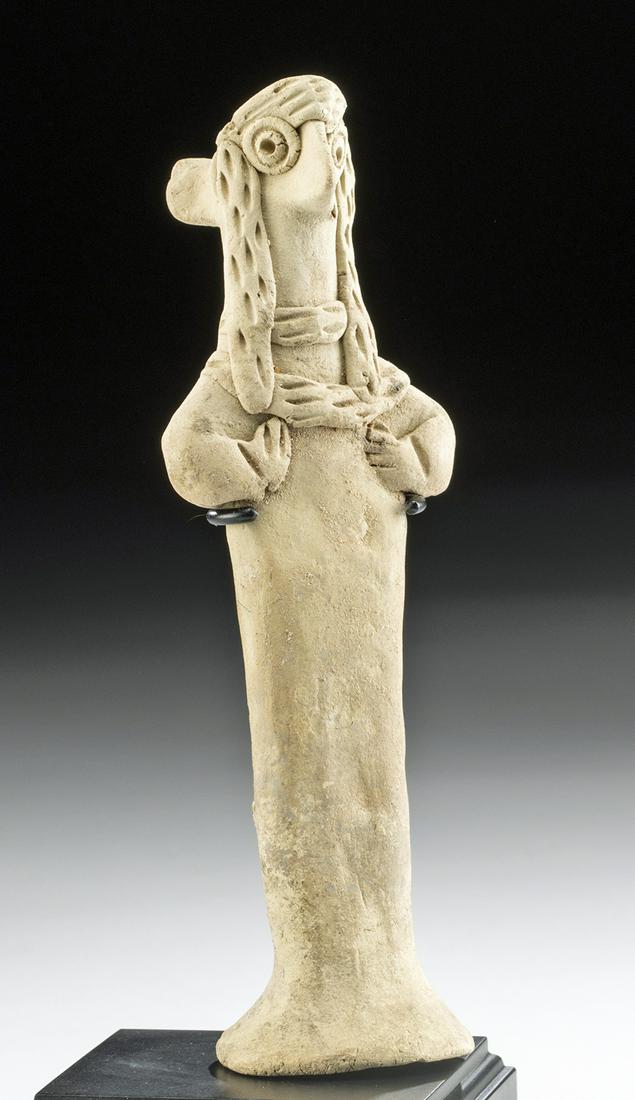 Syro Hittite Pottery Standing Fertility Idol: Ancient Near East, northern Syria, Syro-Hittite, ca. 3rd millennium BCE. A fine example of a hand-built pottery female fertility idol with tan-hued slip enveloping the exterior. The graceful figure st