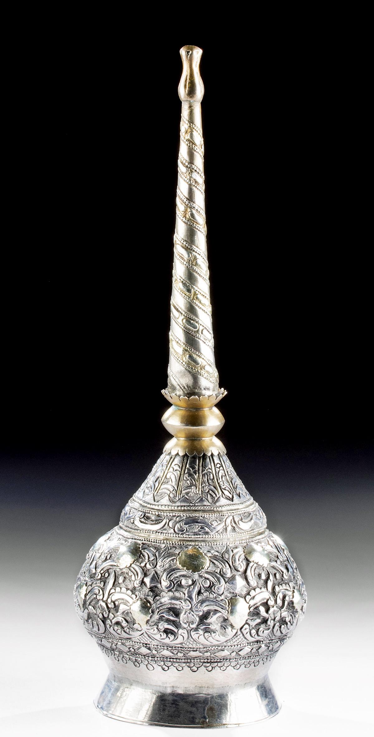 19th C. Persian Silver Long Necked Bottle - 251.7 g: Western Asia, Persia (Iran), ca. 19th century CE. A lovely 92% silver bottle with a low, flaring foot, a spherical body decorated with ornate floral repousse, and a long, tapering spout that ends in a