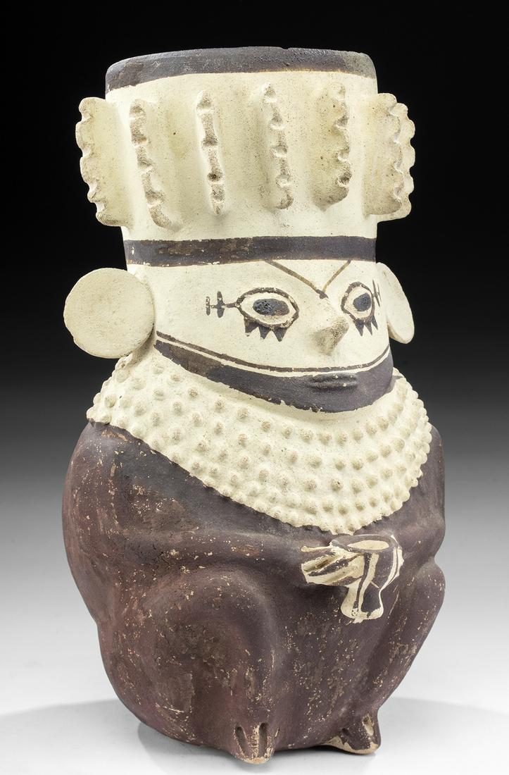 Chancay Bi-chrome Star Gazer Holding Kero: Pre-Columbian, Chancay culture, Peru, ca. 800 to 1200 CE. Wow! A great example of a classic Chancay form, a star gazer holding a kero. The vessel is a bi-chrome earthenware egg-shaped effigy, with the