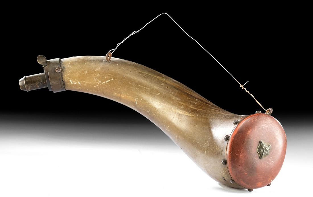 18th C. American Powderhorn w/ Brass Wolf: North America, American, ca. later 18th century CE. A fine example of a powderhorn with a brass tip and painted red wood cap with a brass decorative pin in the form of a wolf head. Powderhorns were an