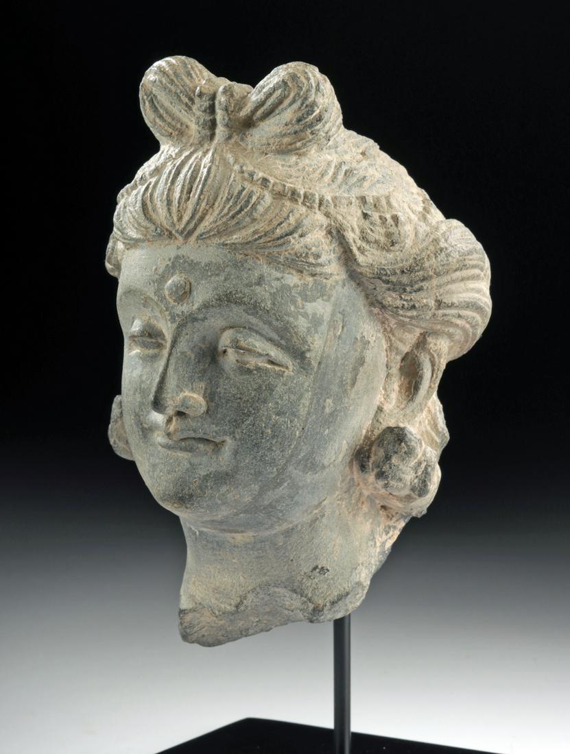 Gandharan Schist Head of Prince Siddhartha: **Originally Listed At $1200** Central Asia, Pakistan and Afghanistan, Gandharan Empire, ca. 200 BCE to 100 CE. An evocative hand-carved grey schist head of Prince Siddhartha as he becomes Buddha, pre