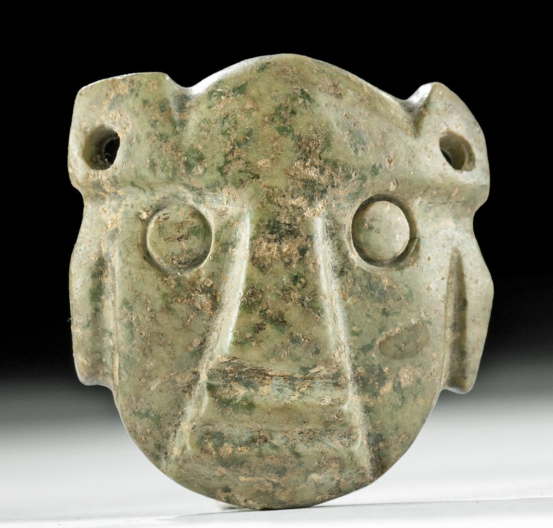 Unusual Guerrero Mezcala Greenstone Face Pendant: **First Time At Auction** Pre-Columbian, southern Mexico, Guerrero region, Mezcala culture, ca. 500 to 200 BCE. An intriguing example of a highly stylized face pendant of an ovoid form that is hand-ca