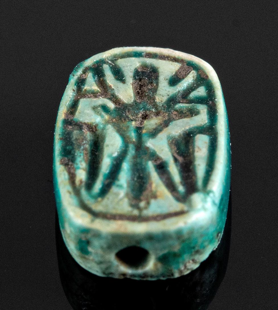 Egyptian Faience Bead w/ 4 Uraeus Cobras, ex-Mitry: **Originally Listed At $200** Ancient Egypt, New Kingdom period, 18th to 20th Dynasty, ca. 1549 to 1076 BCE. A miniature faience bead of an ovoid form with smooth peripheries, a lengthwise suspension 