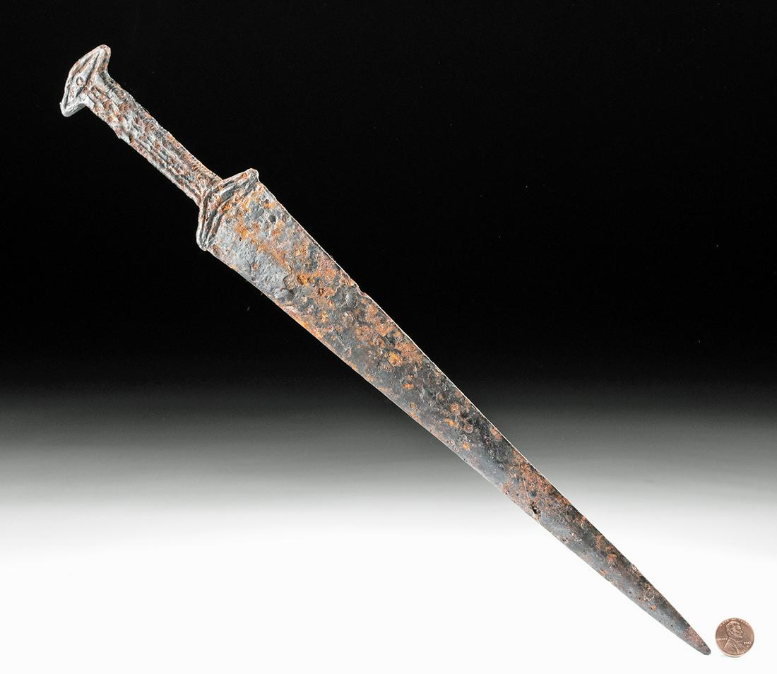 Scythian Iron Short Sword / Dagger - Acinaces: Central Asia, Scytho-Siberian, ca. 5th century BCE. A gorgeous, rare, iron dagger with a long, thin blade and a guard and hilt with abstract zoomorphic decorations. The guard/hilt would have been made