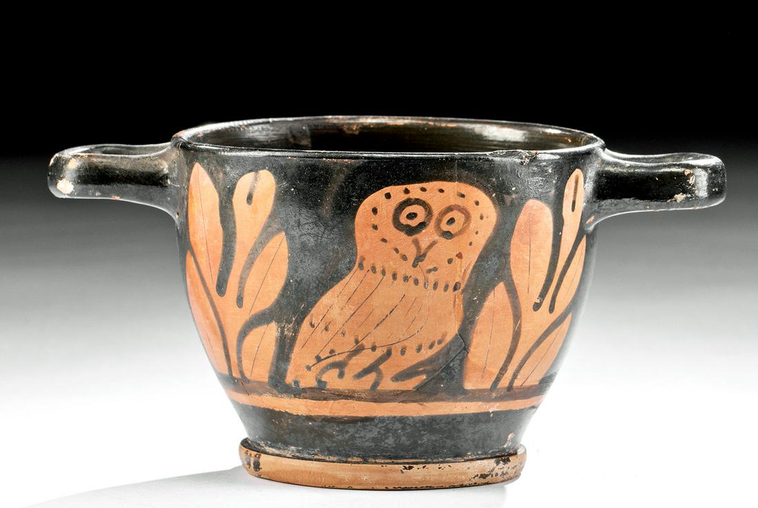 Greek Apulian Red-Figure Owl Skyphos: Magna Graecia, South Italy, Apulia, ca. 340 to 325 BCE. A South-Italic interpretation of an Attic form, this skyphos is comprised of a dual-handled, deep cup with a low flanged base, and the walls are