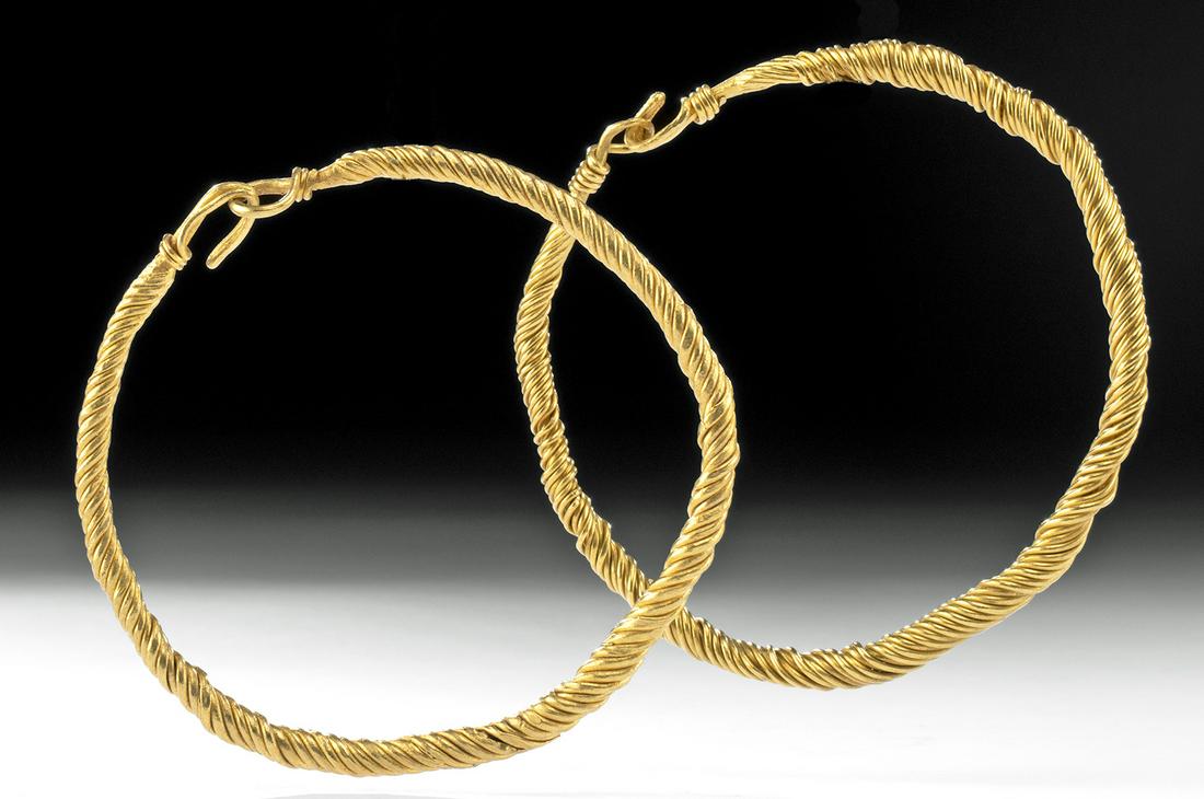 Pair Greek Hellenistic 22K+ Gold Bracelets, 116 g: Ancient Greece, Hellenistic, ca. 3rd to 2nd century BCE. A stunning pair of wearable broad bracelets comprised of tightly twisted wires of 94% gold (equivalent to 22K+). Each hoop-shaped body spirals 