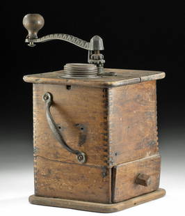 19th C. American Wood and Brass Coffee Grinder: North America, Western USA, ca. 19th century CE. A charming antique coffee grinder, with a tall wooden box containing a chamber for grinding and a drawer for holding the results. A tall wood-handled