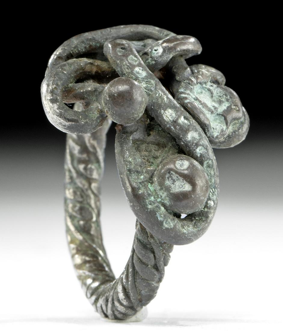 Viking Silver Ring w/ Intertwined Details, 11.8 g: Northern Europe, Viking or Norse culture, ca. 8th to 10th century CE. A fine Viking ring formed from 88% silver with a spiraling shank and a bulbous body. The top of the body is wrapped with a thick s