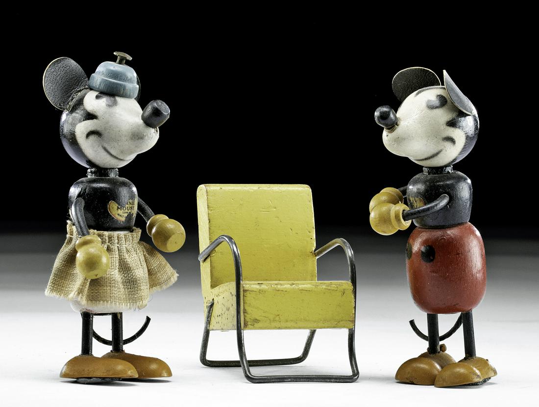 1930s Walt Disney Figurines - Mickey, Minnie, & Chair: United States, Walt Disney, ca. 1930s. Antique wooden Disney Mickey and Minnie Mouse figures and accompanying miniature yellow wood and metal chair. Both Mickey and Minnie have traces of their origina