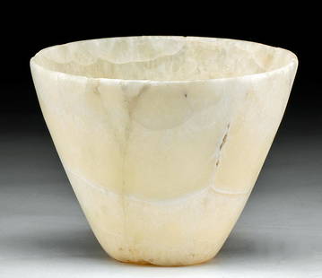 Fine Egyptian Banded Alabaster Bowl: Egypt, Late Dynastic Period, 26th to 31st Dynasty, ca. 664 to 332 BCE. A gorgeous bowl of a broad, conical form that is hand-carved from translucent yellow-white alabaster with opaque white bands