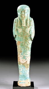 Tall Egyptian 26th Dynasty Glazed Faience Ushabti: Egypt, Late Dynastic Period, 26th Dynasty, ca. 664 to 525 BCE. A mold-formed faience ushabti of a tall form that is covered in lustrous blue glaze. The figure stands in mummiform with fused legs atop