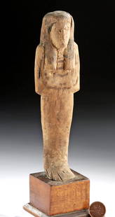 Rare Egyptian Late Dynastic Wooden Ushabti: Egypt, Late Dynastic Period, 26th to 31st Dynasty, ca. 664 to 332 BCE. A rare example of an ushabti carved from hard wood. The figure stands in mummiform with fused legs atop a short, integral