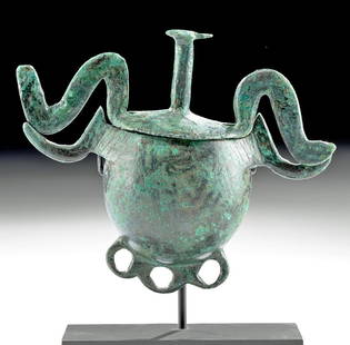 Archaic Greek Bronze Lidded Pyxis w/ Bird Protomes: Ancient Greece, Geometric period, ca. 8th century BCE. Skillfully cast via the lost wax (cire perdue) process, a lidded pyxis presenting an ever-so-slightly flattened globular body, a pair of