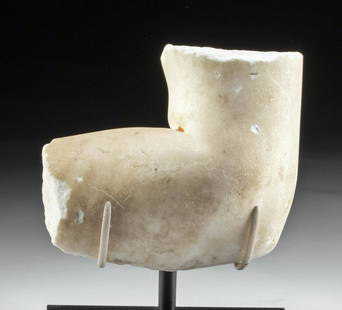 Roman Marble Elbow Fragment: Roman, Imperial Period, ca. 2nd century CE. A finely carved white marble section of an arm bent at the elbow, presenting the naturalism aspired to in the Classical World. Notice the veristic modeling