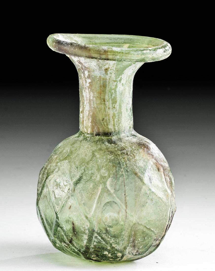 Roman Glass Sprinkler Flask w/ Net Motif: Roman, late Imperial Period, ca. late 3rd to early 5th century CE. A beautiful sprinkler flask that is mold-formed from translucent, green-hued glass with integral streaks of red-purple glass along th