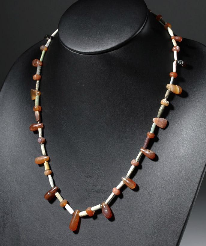 Ancient Persian Faience / Carnelian Beaded Necklace: Ancient Near East, Persia, Iran, ca. 1000 BCE. A modern stringing of beads from ancient Persia. Teardrop-shaped carnelian beads are spaced with long bugle beads made of different white, grey, green, a